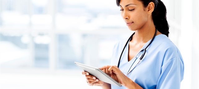 Telehealth/Remote Patient Care: Female hospital staff with tablet.